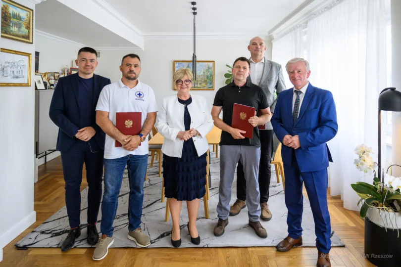Zdjęcie przedstawia uczestników uroczystości podpisania umowy na wsparcie ratownictwa wodnego