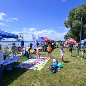 Zdjęcie przedstawia uczestników pikniku edukacyjnego nad Jeziorem Tarnobrzeskim