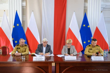 Zdjęcie przedstawia uczestników podpisania umów w ramach programu ochrony ludności i obrony cywilnej