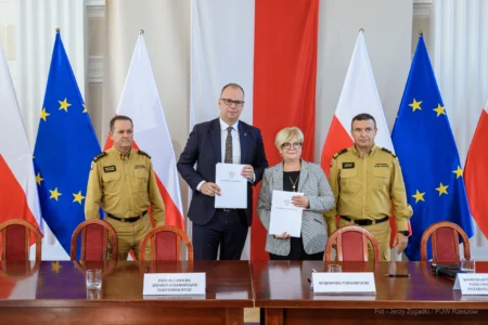 Zdjęcie przedstawia uczestników podpisania umów w ramach programu ochrony ludności i obrony cywilnej