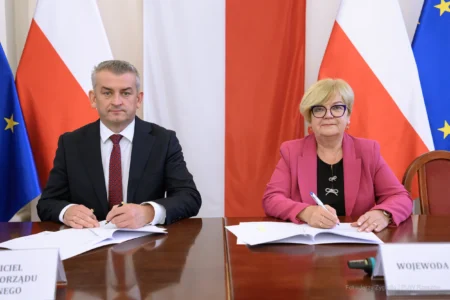 Zdjęcie przedstawia uczestników podpisania umów w ramach programu ochrony ludności i obrony cywilnej